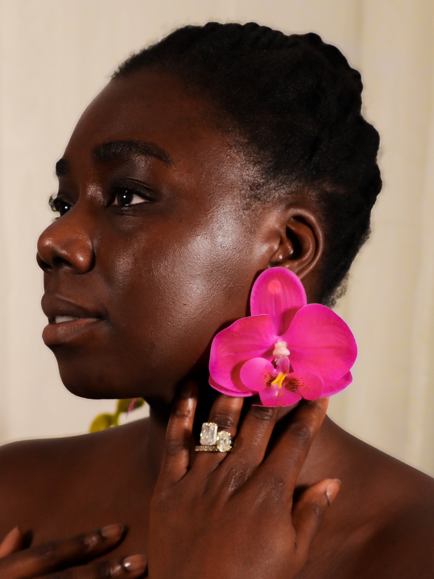 Woman wearing violetorchid earrings with a neutral background